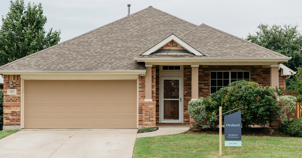 Orchard home with for sale sign