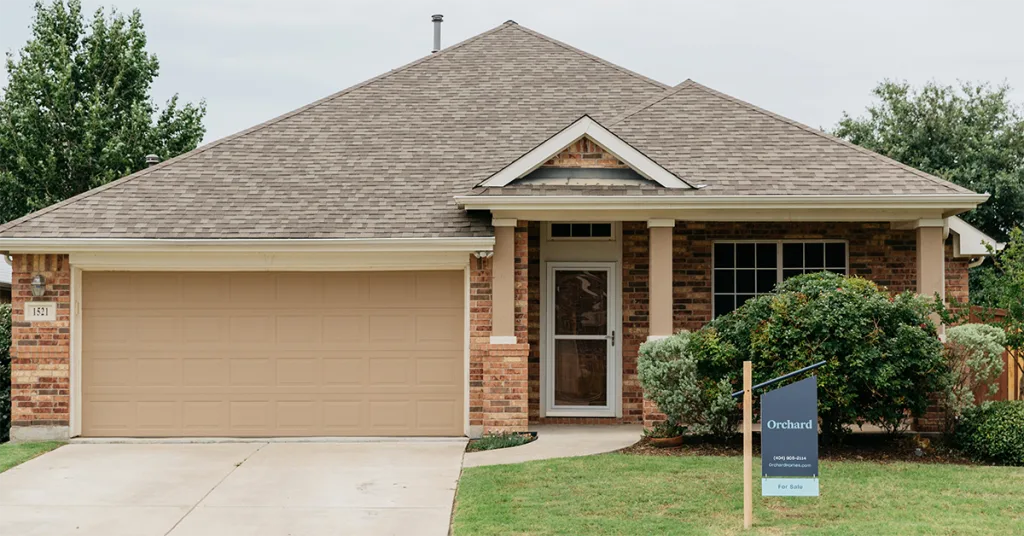Orchard home with for sale sign
